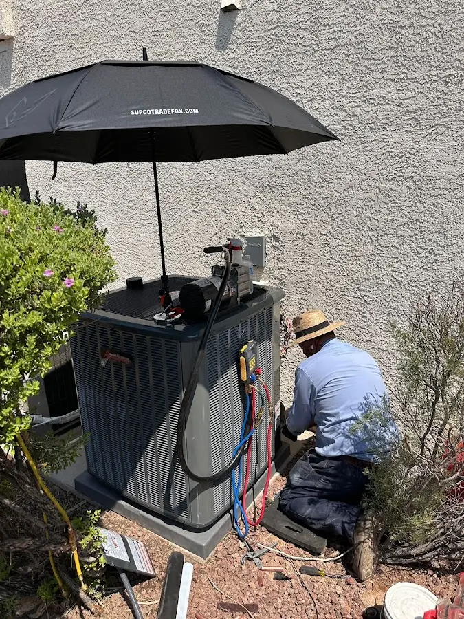 HVAC technician performing outdoor AC maintenance in Ladera Ranch
