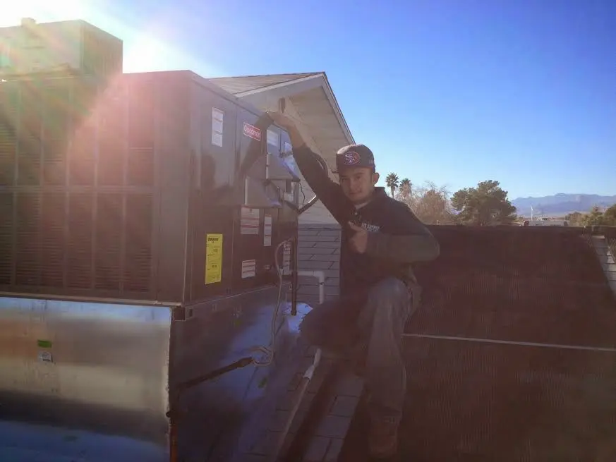 HVAC technician performing HVAC Inspection on a rooftop unit in Ladera Ranch